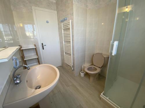une salle de bain avec un lavabo, des toilettes et une douche dans l'établissement Maison Familiale à Fouras : Plages, Jardin, Garage - FR-1-709-38, à Fouras