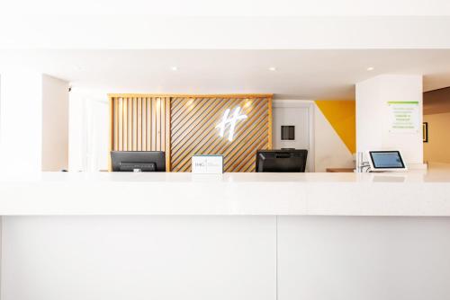an office with a lobby with two computers at Holiday Inn Preston by IHG in Preston