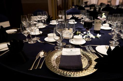 a table with wine glasses and a plate with a napkin at Holiday Inn Incheon Songdo by IHG in Incheon