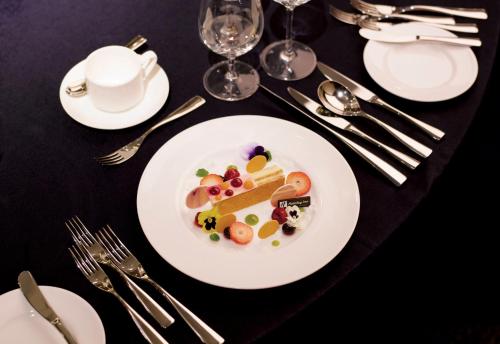 a plate with a piece of cake on a table at Holiday Inn Incheon Songdo by IHG in Incheon