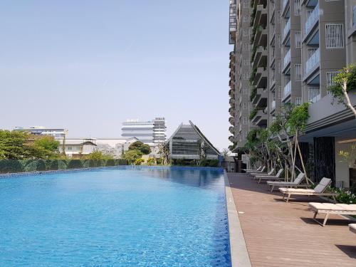 a large swimming pool next to a building at New! Luxury Landmark Residence Apartment 2+1BR 96m in Bandung