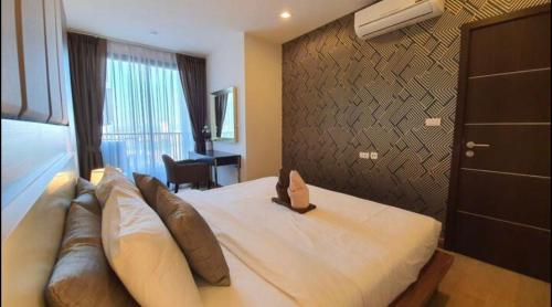 a hotel room with a large bed with a couch at The Astra,City center,Best view,Big room,5mins,Night Market in Chiang Mai