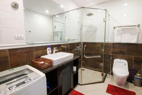 a bathroom with a shower and a sink and a toilet at Khách sạn Le Domaine De Cocodo in Hue