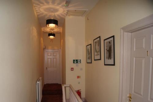 a hallway with a staircase with a light and a ceiling at Admiral MacBride in Plymouth