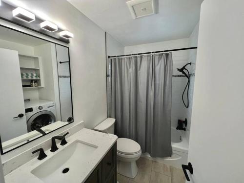 a bathroom with a sink and a toilet and a shower at Central Penticton. Alongside KVR Trail. Freshly Renovated. Pet Friendly. in Penticton