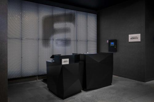 a room with black and white walls and a person at Aloft Orlando Lake Buena Vista in Orlando