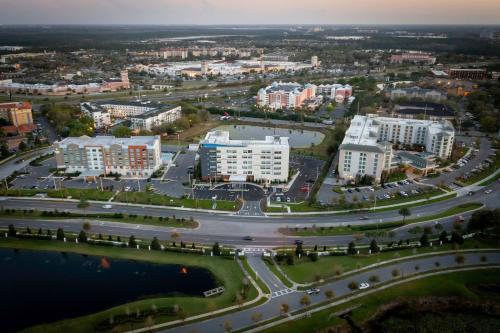 an aerial view of a city with buildings and water at Aloft Orlando Lake Buena Vista in Orlando