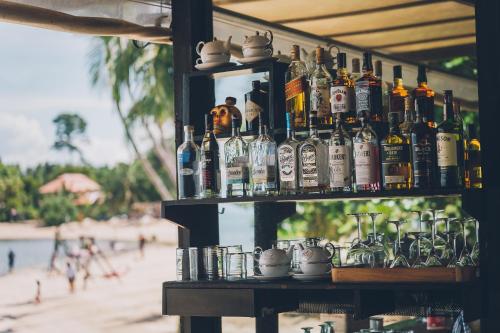 a shelf with bottles of alcohol on a beach at Chill Inn Lamai Hostel & Beach Cafe in Koh Samui 