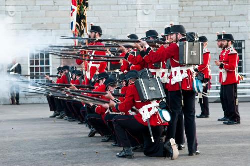 a group of people in red uniforms playing musical instruments at Holiday Inn Kingston - Waterfront by IHG in Kingston