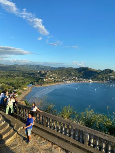 a group of people standing on a ledge overlooking a lake at Looking Good Surf House San Juan del Sur in San Juan del Sur