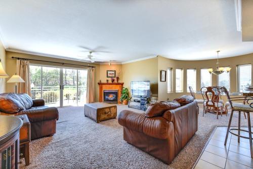 a living room with two leather couches and a fireplace at Golf Vista 111 in Pigeon Forge