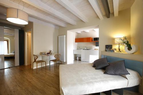 a bedroom with a bed and a living room at Corte San Luca Apartments in Bardolino