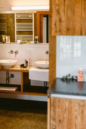 a bathroom with two sinks and a counter at Seehotel Berau in St. Wolfgang