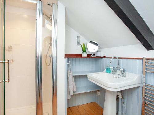 a bathroom with a sink and a shower at The Coach House in South Zeal