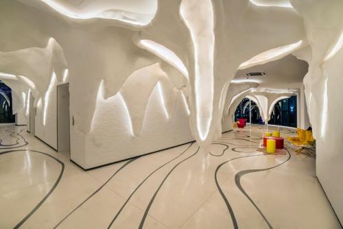 a room with a white wall with trees on it at Arte Plus Kuala Lumpur in Kuala Lumpur