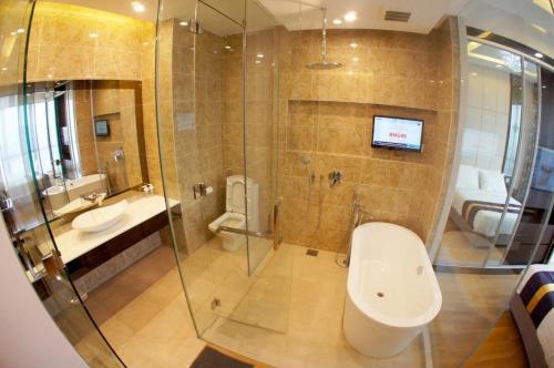 a bathroom with a shower and a toilet and a sink at Dorsett Residences Bukit Bintang in Kuala Lumpur