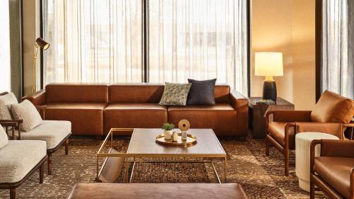 a living room with a couch and a table at Staybridge Suites Chicago O'Hare - Rosemont by IHG in Rosemont