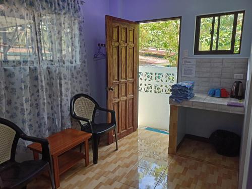 a room with a desk and a table and a window at Sky Beach Hotel in Catmon