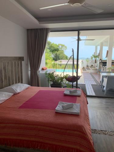 a bedroom with a bed and a view of a pool at La Villa Noi in Ban Ko Khwan
