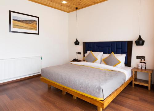a bedroom with a large bed in a room at The Dunes Boutique Hotel in Charāsa