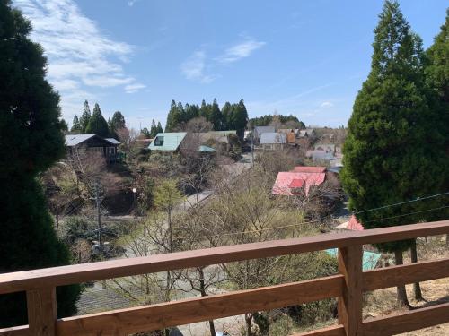 a view of a town from a wooden fence at 黒川　天空の城 in Minamioguni