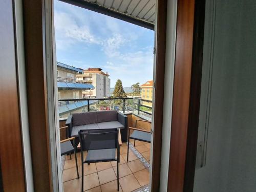 a view of a balcony with a table and chairs at Baiona, primera línea de Playa Ladeira, terraza. in Baiona