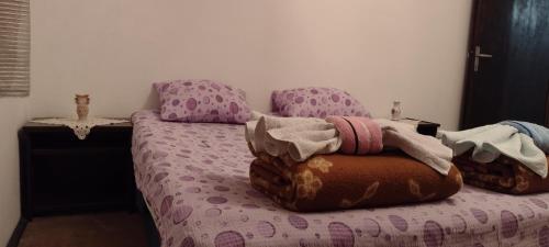 a bedroom with a bed with a purple head board at Stefanovića kuća in Babušnica