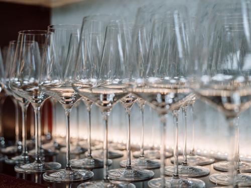 a row of wine glasses sitting on a table at Air-conditioned, quiet Apartment - center of Sankt Pölten - Smart TV in Sankt Pölten