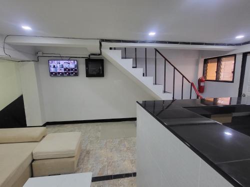 a room with a staircase with a tv on the wall at THE NEST in Pattaya