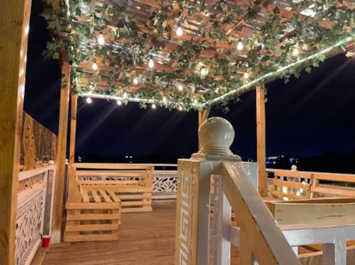a deck with a pavilion with lights on it at Elegant 1-Bed With Unlimited Starlink SuperFast Speed WiFi & 24hrs POWER in Lagos