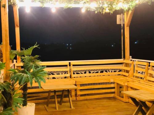 a wooden porch with a bench and a table at Elegant 1-Bed With Unlimited Starlink SuperFast Speed WiFi & 24hrs POWER in Lagos