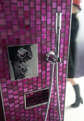 a picture of a camera on a purple tiled wall at Hotel Oleana in Bergen