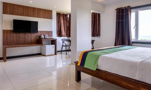 Ein Bett oder Betten in einem Zimmer der Unterkunft Treebo Rushi Grand