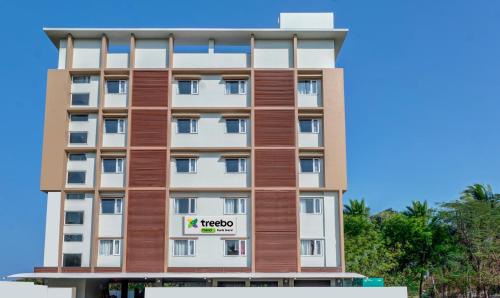 a hotel building with a hotel sign on it at Treebo Trend Rushi Grand in Visakhapatnam