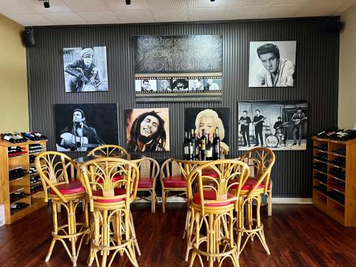 a restaurant with a table and chairs and pictures on the wall at Mirambeena Motel in Whyalla