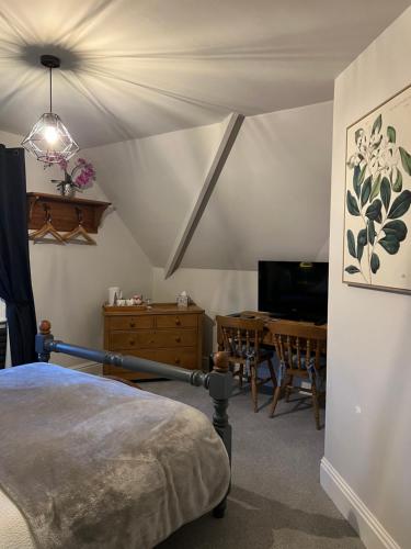 a bedroom with a bed and a dining room table at Overdale Guesthouse and Free Parking in Whitby