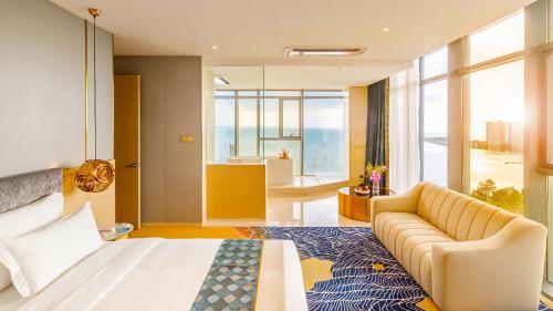 um quarto de hotel com uma cama e um sofá em Won Majestic Hotel Cambodia em Sihanoukville