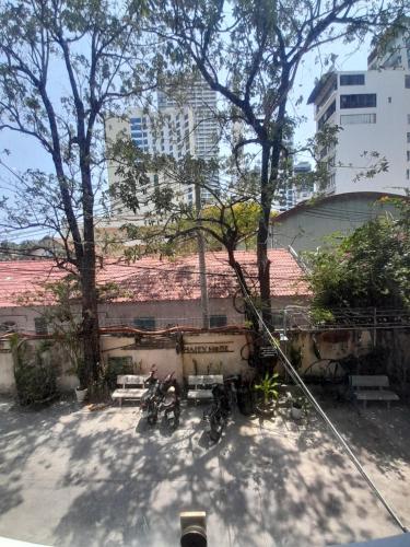 a group of bikes parked in a courtyard with trees at Happy Home in Nha Trang