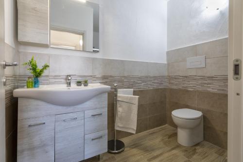 uma casa de banho com um lavatório e um WC em Sole e Mare 2 em Castelsardo