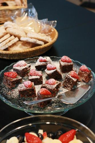 un piatto di brownie e fragole su un tavolo di Hotel Sofia a Helsinki