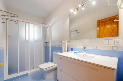 a bathroom with a toilet and a sink and a shower at S'hort des Baladres Ibiza Villa in Santa Eularia des Riu