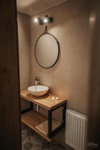 a bathroom with a sink and a mirror on a wall at Le vieux Sanglier - 41 pers - Malmedy in Malmedy