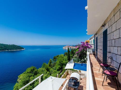 a balcony with chairs and a view of the water at Villa Adrian in Dubrovnik
