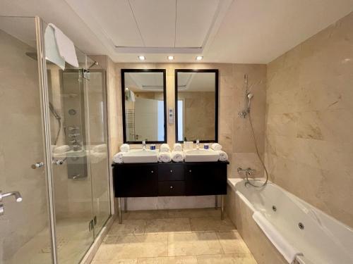 a bathroom with a sink and a shower and a tub at Apartamento VISTA MAR in Casares