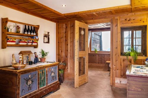 a kitchen with wood paneling and a wooden door at Feldererhof Apt Hochstein in Santa Maddalena