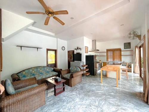 a living room with a couch and a table at The Beach Samui in Taling Ngam Beach