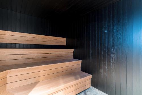 a sauna with wood paneling and a black wall at Quality Hotel Grand, Borås in Borås