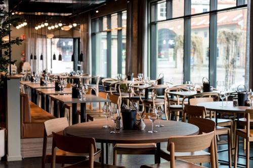 a row of tables and chairs in a restaurant at Quality Hotel Grand, Borås in Borås