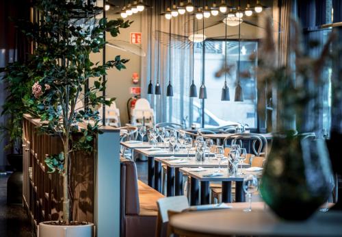 a row of tables and chairs in a restaurant at Quality Hotel Grand, Borås in Borås