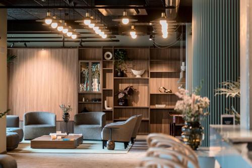 a lobby with chairs and a table in a room at Quality Hotel Grand, Borås in Borås
